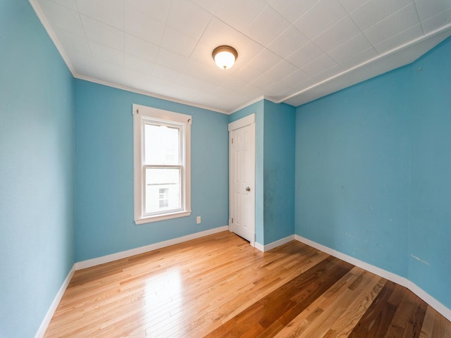 1534 9th St, Des Moines, IA 50314 - spare room featuring ornamental molding and hardwood / wood-style floors