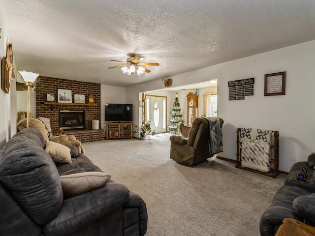 1439 N Shore Dr, Knoxville, IA 50138 - carpeted living room featuring ceiling fan, a textured ceiling, and a fireplace