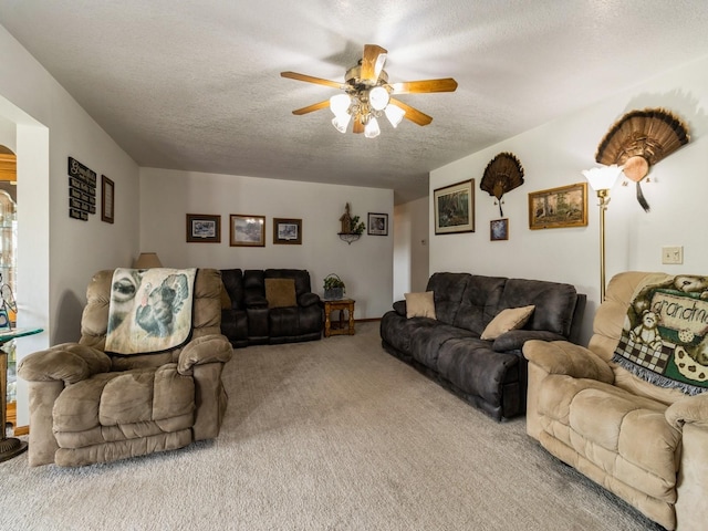 1439 N Shore Dr, Knoxville, IA 50138 - carpeted living room with a textured ceiling and ceiling fan