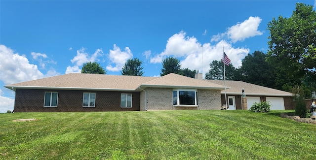 1439 N Shore Dr, Knoxville, IA 50138 - view of front of home with a garage, a front yard, brick siding, and a chimney