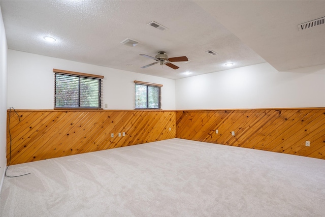 3600 E 42nd Ct, Des Moines, IA 50317 - unfurnished room with wooden walls, a wainscoted wall, ceiling fan, carpet flooring, and recessed lighting