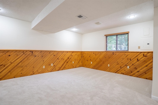 3600 E 42nd Ct, Des Moines, IA 50317 - carpeted empty room featuring wood walls, wainscoting, and electric panel