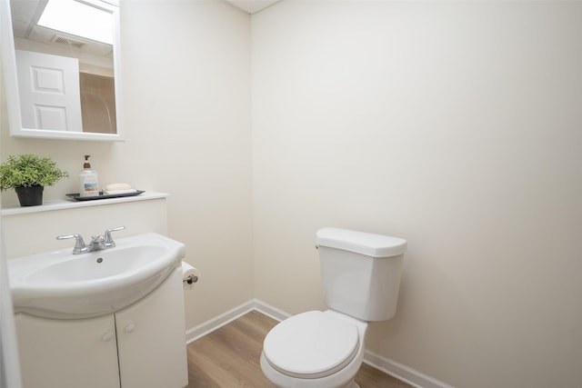 3600 E 42nd Ct, Des Moines, IA 50317 - half bathroom featuring wood finished floors and vanity
