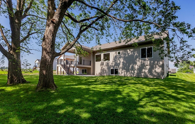 519 16th Avenue Ct SE, Altoona, IA 50009 - back of property with stairs, a lawn, and a deck