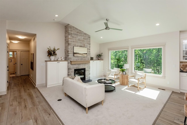 519 16th Avenue Ct SE, Altoona, IA 50009 - living room with light wood-style flooring, ceiling fan, a fireplace, vaulted ceiling, and recessed lighting