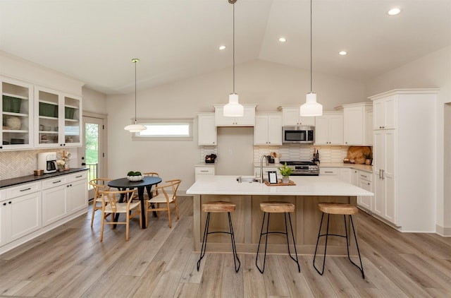 519 16th Avenue Ct SE, Altoona, IA 50009 - kitchen with backsplash, a breakfast bar, white cabinets, recessed lighting, and high vaulted ceiling