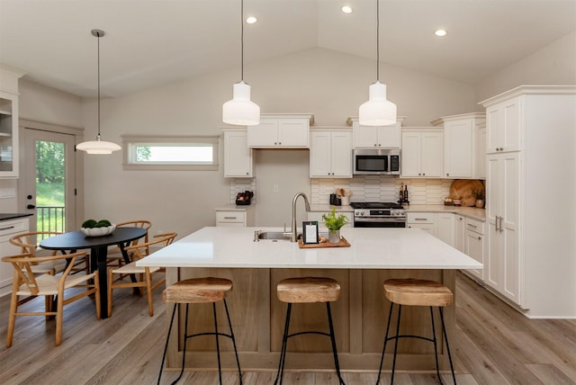519 16th Avenue Ct SE, Altoona, IA 50009 - kitchen featuring appliances with stainless steel finishes, light wood-type flooring, white cabinets, recessed lighting, and high vaulted ceiling