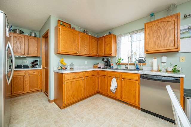 9102 NW Windsor Dr, Johnston, IA 50131 - kitchen with appliances with stainless steel finishes, light countertops, and brown cabinetry