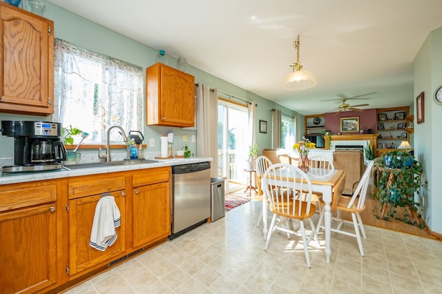 9102 NW Windsor Dr, Johnston, IA 50131 - kitchen featuring dishwasher, light countertops, a ceiling fan, light floors, and brown cabinetry