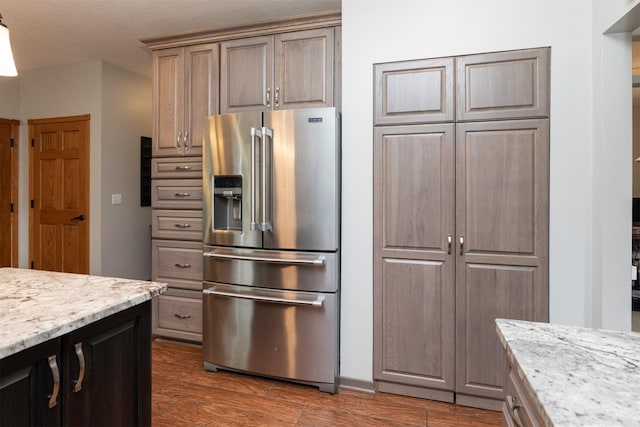 5526 Kensington Cir, Johnston, IA 50131 - kitchen with high end refrigerator, dark wood-type flooring, and light stone countertops