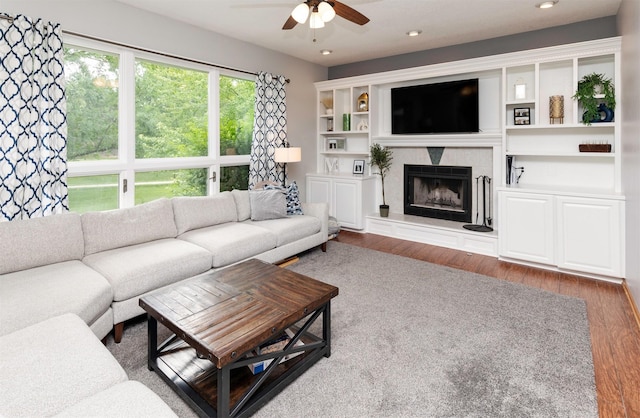 5526 Kensington Cir, Johnston, IA 50131 - living room with a ceiling fan, wood finished floors, a premium fireplace, and recessed lighting