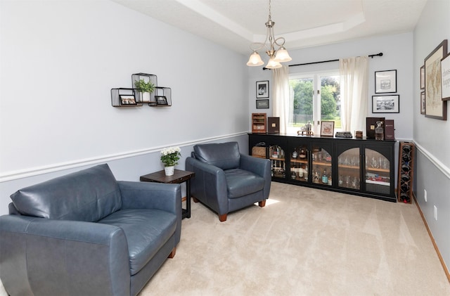 5526 Kensington Cir, Johnston, IA 50131 - sitting room with carpet floors, a tray ceiling, and a chandelier