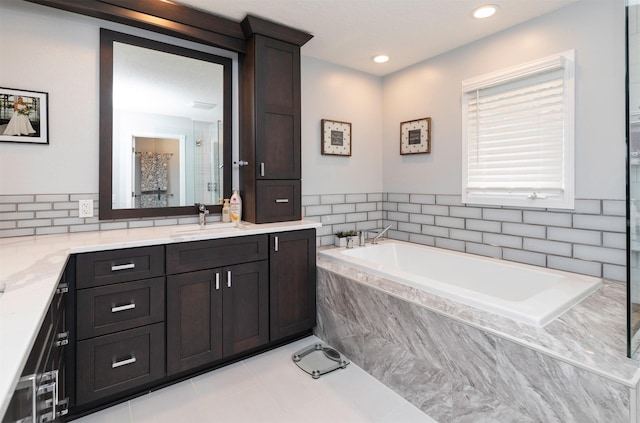 5526 Kensington Cir, Johnston, IA 50131 - bathroom featuring vanity, a bath, tile patterned floors, recessed lighting, and a shower