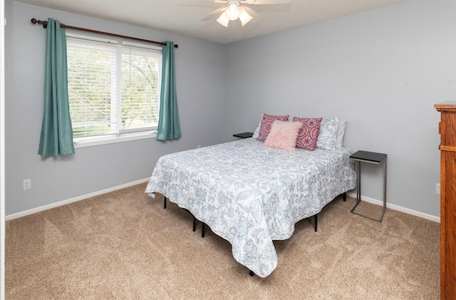 5526 Kensington Cir, Johnston, IA 50131 - carpeted bedroom with baseboards and a ceiling fan