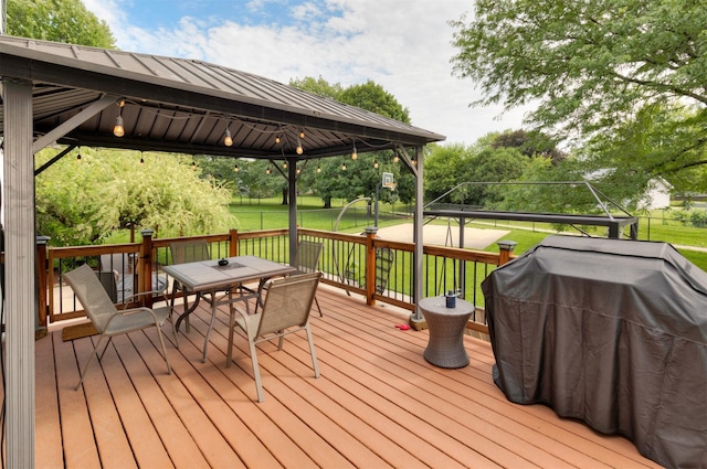 5526 Kensington Cir, Johnston, IA 50131 - wooden deck with a gazebo, area for grilling, outdoor dining area, and a lawn