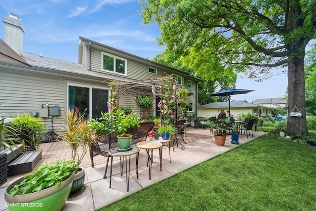 4505 75th St, Urbandale, IA 50322 - rear view of house with a patio area and a yard