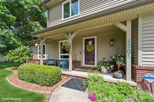 4505 75th St, Urbandale, IA 50322 - doorway to property featuring a porch and brick siding