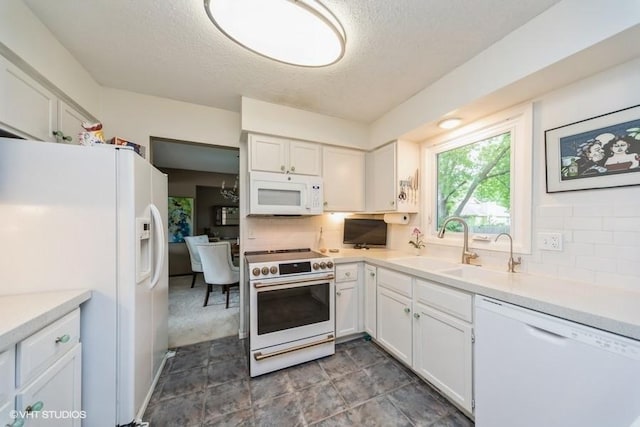 4505 75th St, Urbandale, IA 50322 - kitchen with white appliances, a textured ceiling, white cabinets, tasteful backsplash, and light countertops