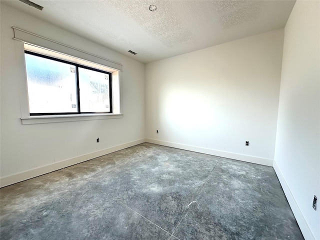 880 Harrington Way, Waukee, IA 50263 - empty room featuring concrete floors and a textured ceiling