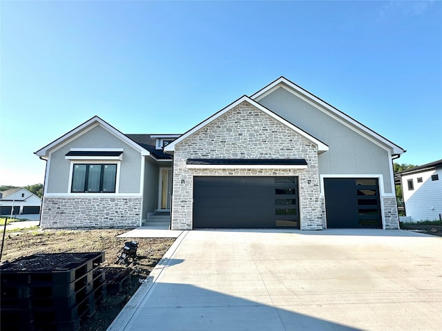 880 Harrington Way, Waukee, IA 50263 - view of front of home with stone siding, a garage, and driveway