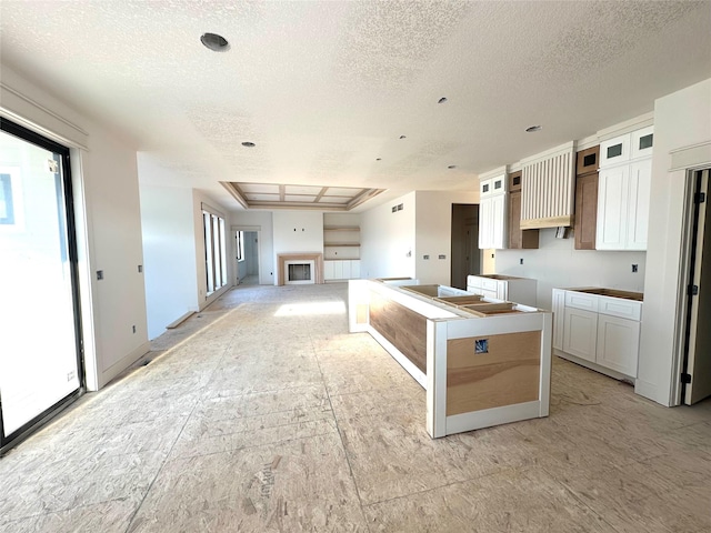 880 Harrington Way, Waukee, IA 50263 - kitchen with a textured ceiling, glass insert cabinets, and white cabinetry