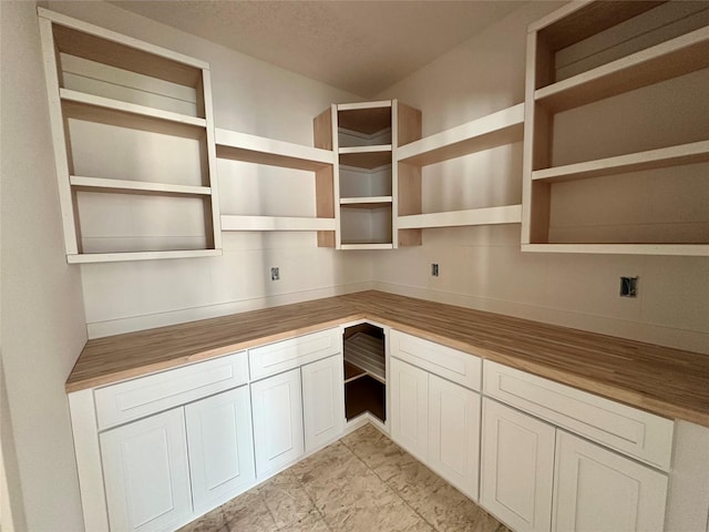 880 Harrington Way, Waukee, IA 50263 - kitchen featuring wood counters, open shelves, and white cabinets