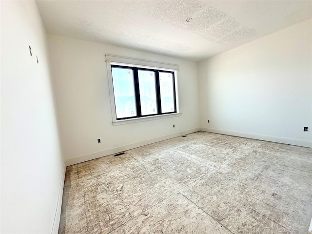 880 Harrington Way, Waukee, IA 50263 - empty room with a textured ceiling and baseboards