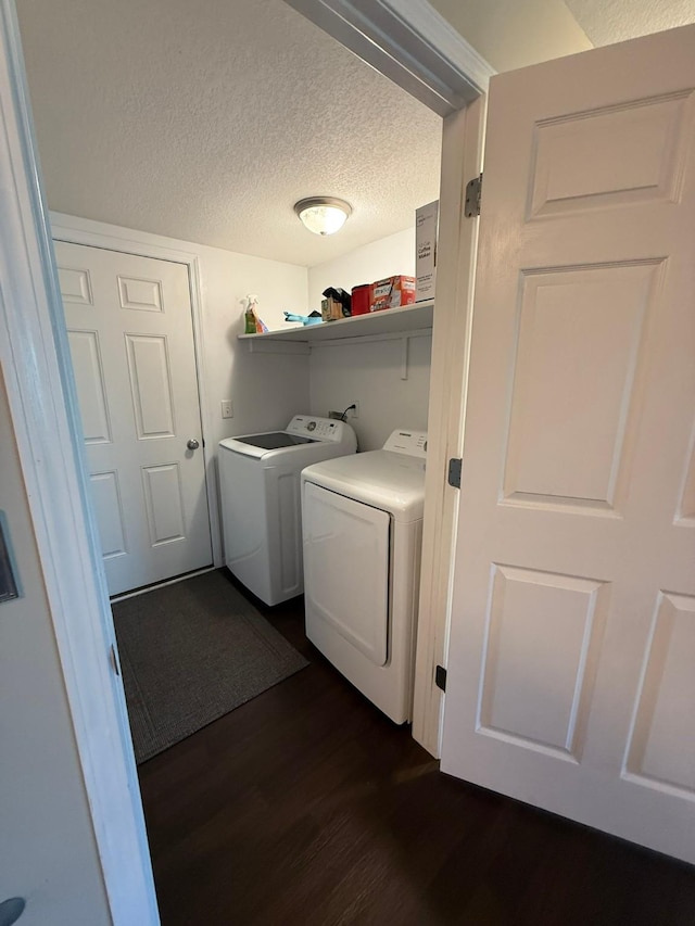 244 4th Ave W, Grinnell, IA 50112 - laundry room featuring washing machine and dryer, dark wood finished floors, and a textured ceiling