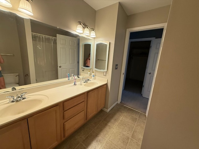 244 4th Ave W, Grinnell, IA 50112 - bathroom featuring double vanity and a shower with curtain