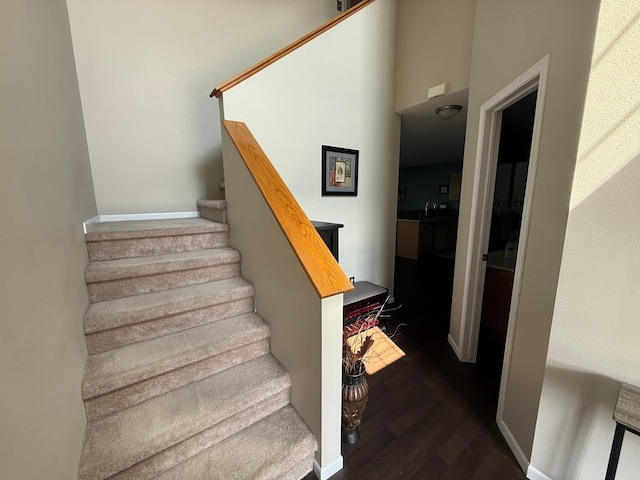244 4th Ave W, Grinnell, IA 50112 - stairway featuring wood finished floors and baseboards