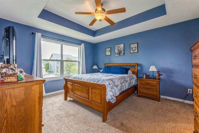 1870 SE Oxford Dr, Waukee, IA 50263 - bedroom featuring a raised ceiling, light colored carpet, and ceiling fan