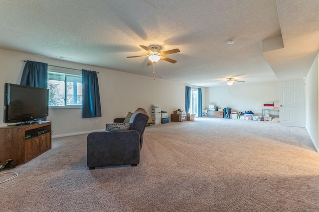 1870 SE Oxford Dr, Waukee, IA 50263 - carpeted living area featuring ceiling fan and a textured ceiling
