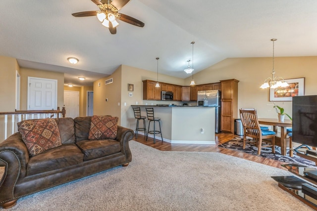 1870 SE Oxford Dr, Waukee, IA 50263 - living area featuring lofted ceiling, a chandelier, a ceiling fan, and dark wood-style floors