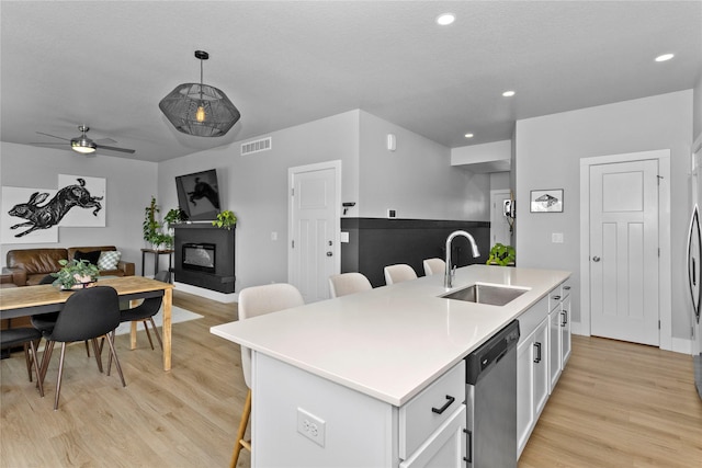 1375 SE Parkview Crossing Dr, Waukee, IA 50263 - kitchen with appliances with stainless steel finishes, open floor plan, a kitchen breakfast bar, light wood-type flooring, and recessed lighting