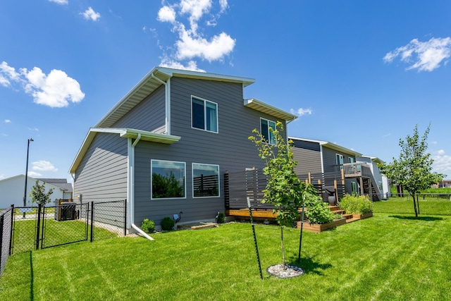 1375 SE Parkview Crossing Dr, Waukee, IA 50263 - back of house with a gate and a vegetable garden