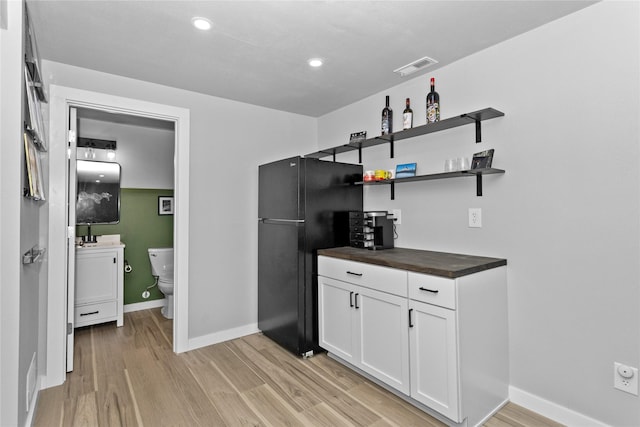 1375 SE Parkview Crossing Dr, Waukee, IA 50263 - indoor dry bar with light wood-style flooring, freestanding refrigerator, and recessed lighting