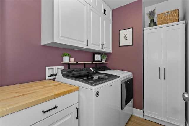 1375 SE Parkview Crossing Dr, Waukee, IA 50263 - washroom featuring washing machine and dryer, cabinet space, and light wood finished floors