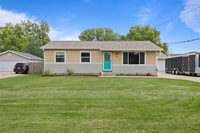6675 NW 5th St, Des Moines, IA 50313 - view of front of home with entry steps, a front lawn, a garage, and a shingled roof