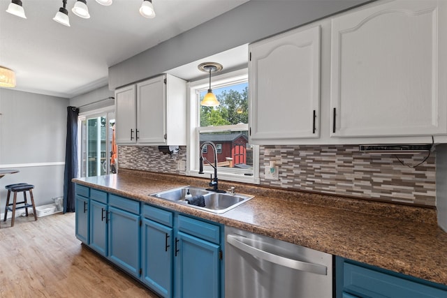 6675 NW 5th St, Des Moines, IA 50313 - kitchen with dishwasher, blue cabinetry, dark countertops, and backsplash