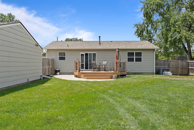 6675 NW 5th St, Des Moines, IA 50313 - back of house featuring a fenced backyard, a wooden deck, and roof with shingles