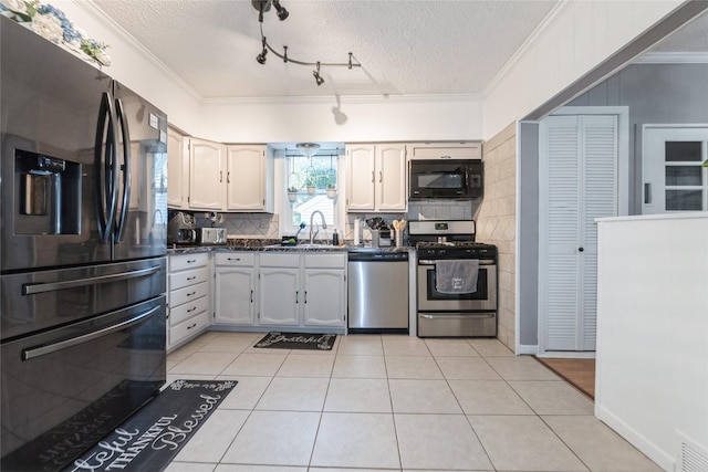 3504 56th St, Des Moines, IA 50310 - kitchen with stainless steel appliances, dark countertops, decorative backsplash, crown molding, and a textured ceiling