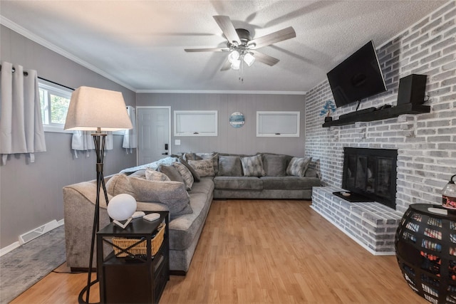 3504 56th St, Des Moines, IA 50310 - living area with wood finished floors, a fireplace, ceiling fan, and crown molding