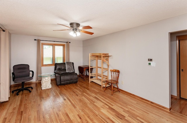 2726 Lakeland Dr, Urbandale, IA 50322 - sitting room with light wood-style floors, a ceiling fan, and a textured ceiling
