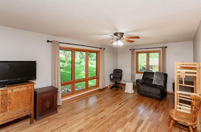 2726 Lakeland Dr, Urbandale, IA 50322 - living area with light wood-style floors, ceiling fan, and a textured ceiling