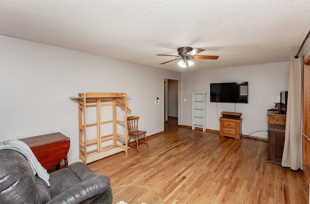 2726 Lakeland Dr, Urbandale, IA 50322 - living room featuring light wood-type flooring, a ceiling fan, and a textured ceiling