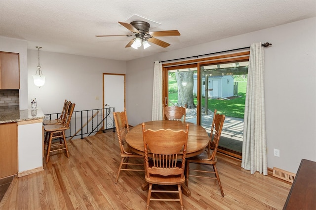 2726 Lakeland Dr, Urbandale, IA 50322 - dining area with light wood-type flooring, a ceiling fan, and a textured ceiling