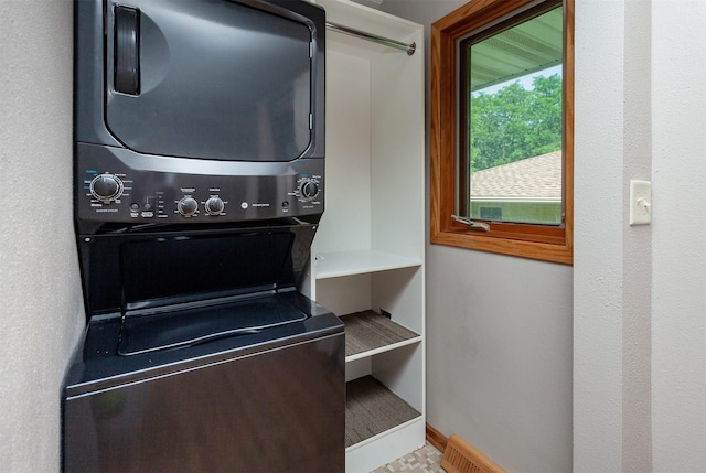 2726 Lakeland Dr, Urbandale, IA 50322 - laundry room with stacked washing machine and dryer and baseboards