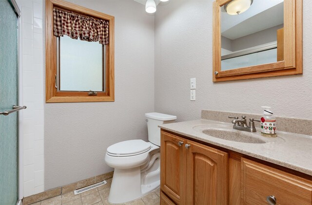 2726 Lakeland Dr, Urbandale, IA 50322 - bathroom featuring vanity, an enclosed shower, and tile patterned floors