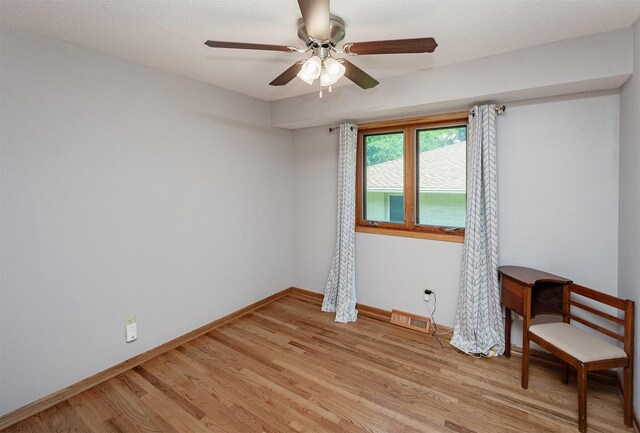 2726 Lakeland Dr, Urbandale, IA 50322 - spare room featuring light wood-style flooring and a ceiling fan