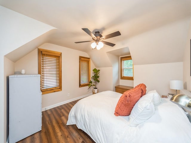 3934 Lincoln Place Dr, Des Moines, IA 50312 - bedroom with dark wood-style flooring, vaulted ceiling, and a ceiling fan
